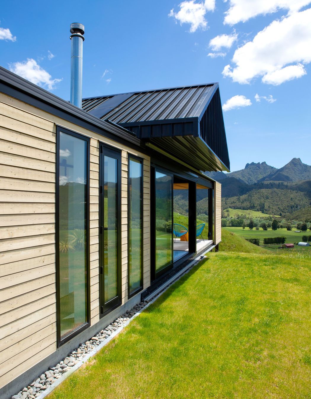 Taking cues from the rural vernacular of farm buildings, in both structure and materiality, the house is simple and uncomplicated, designed to sit lightly on the land.