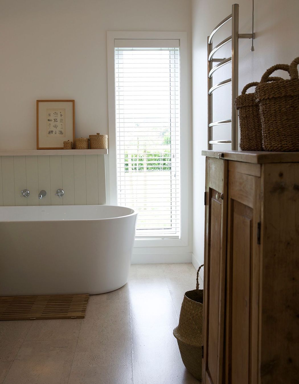 Tall vertical windows are a feature of this home, seen here in the bathroom.