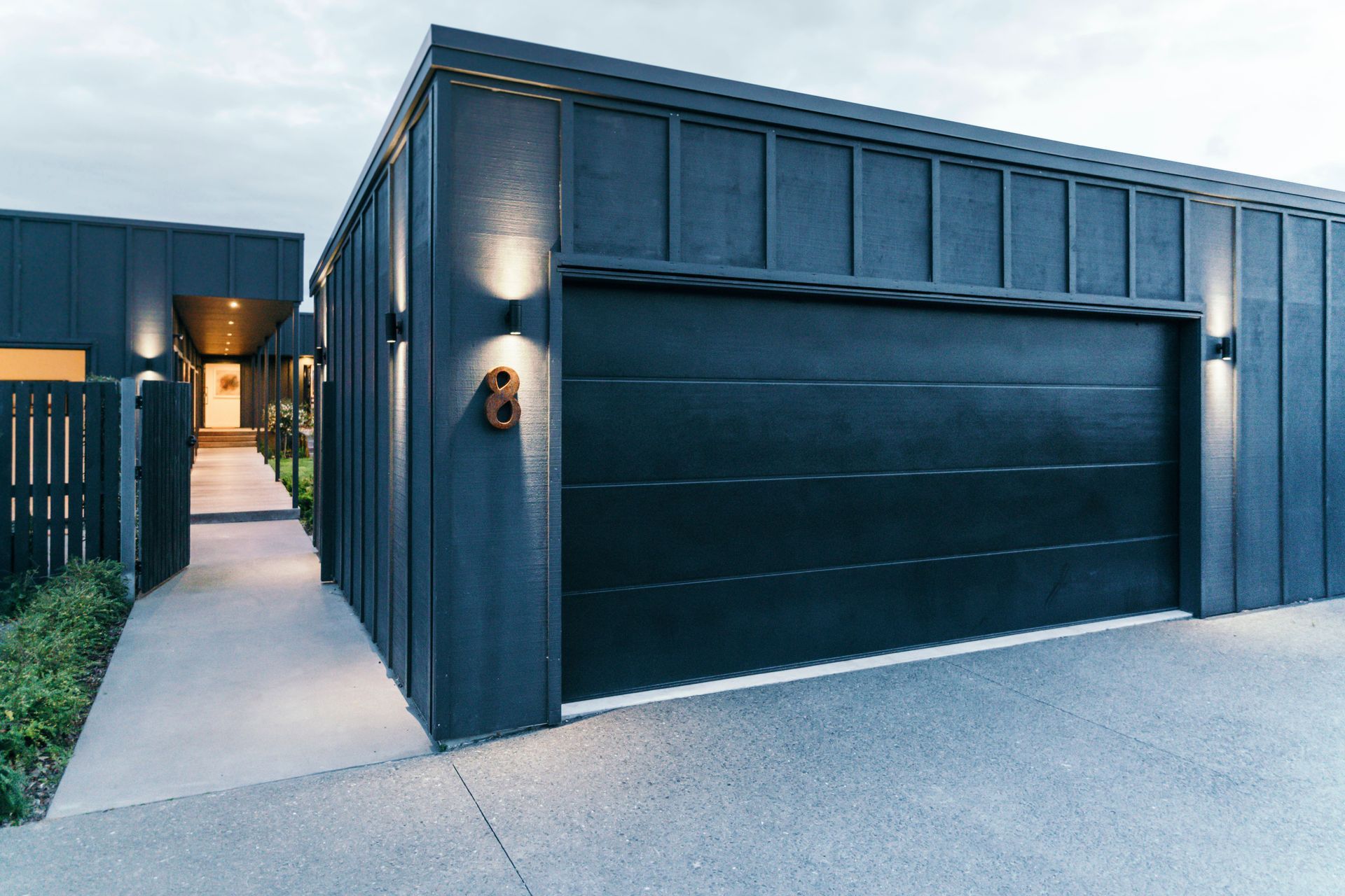 The new garage was placed in front of the property to act as a buffer between the house and the street and also to create an enclosed, internal courtyard.