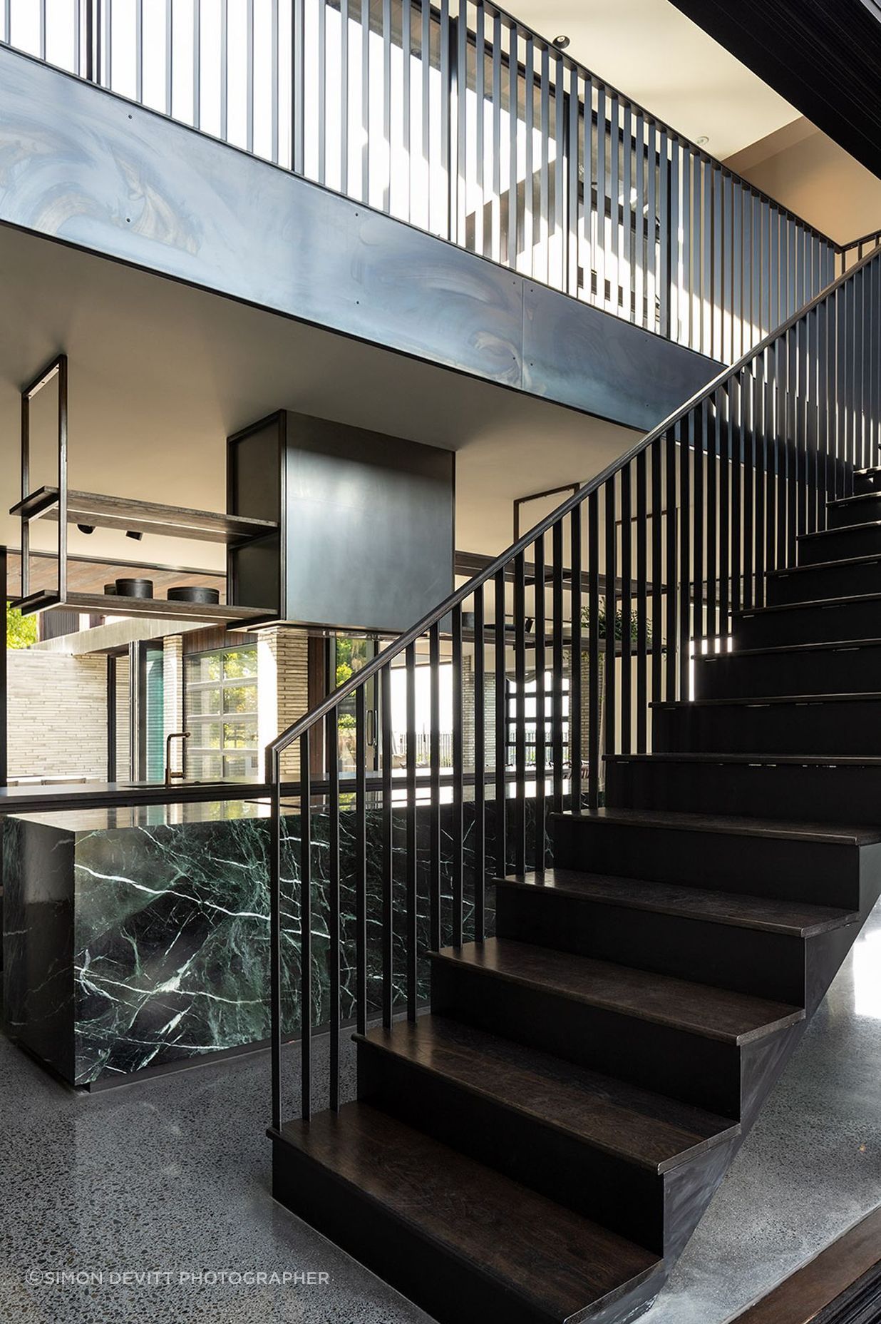 A striking steel balustrade leads to the upper pavilion that houses the private areas of the house.