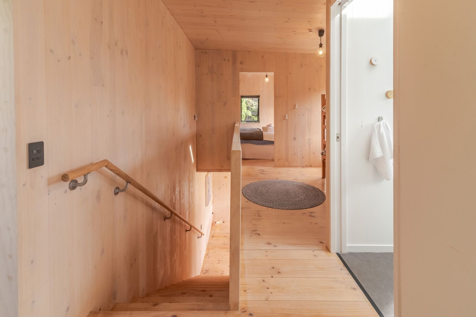 Upstairs, the top of the stairwell and corridor is open to the flexible bunkroom/playspace.