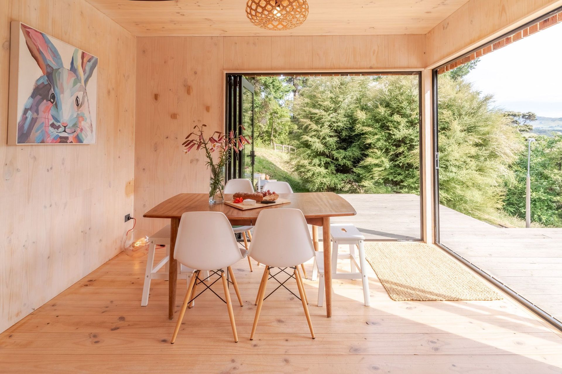 The structural CLT walls are painted with a white wash, creating a contrast with the flooring.