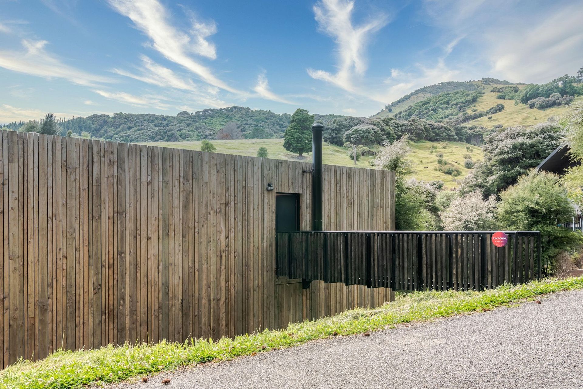 An angled perspective of the bridge entranceway which was constructed from a reused steel structure, manipulated to fit and repainted.