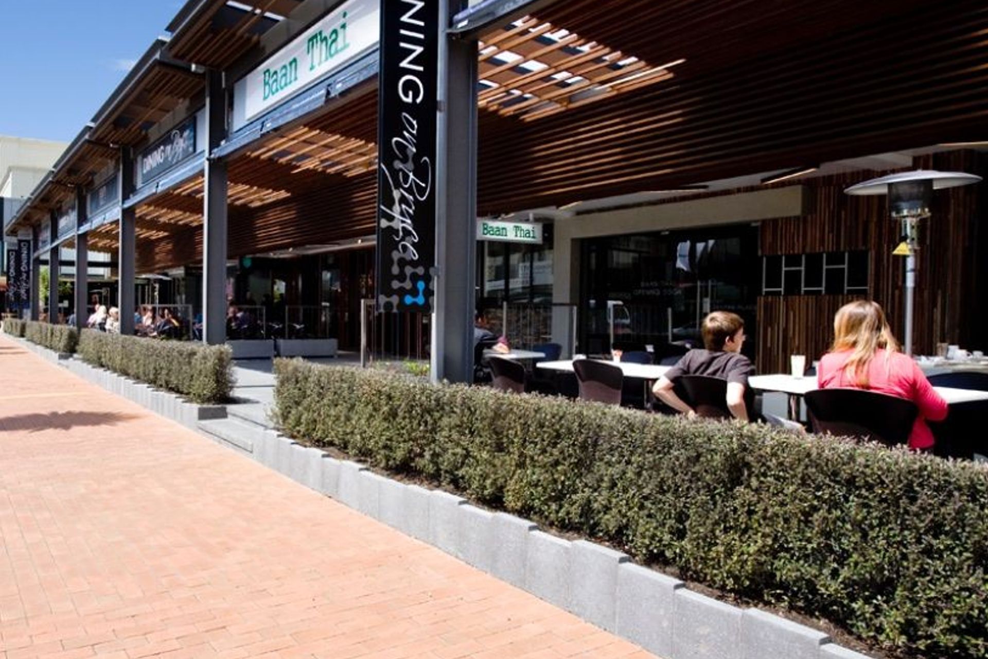 OUTCOME - Living Walls™ instant hedges define the outdoor space, but allow views into and out of these al fresco dining areas.