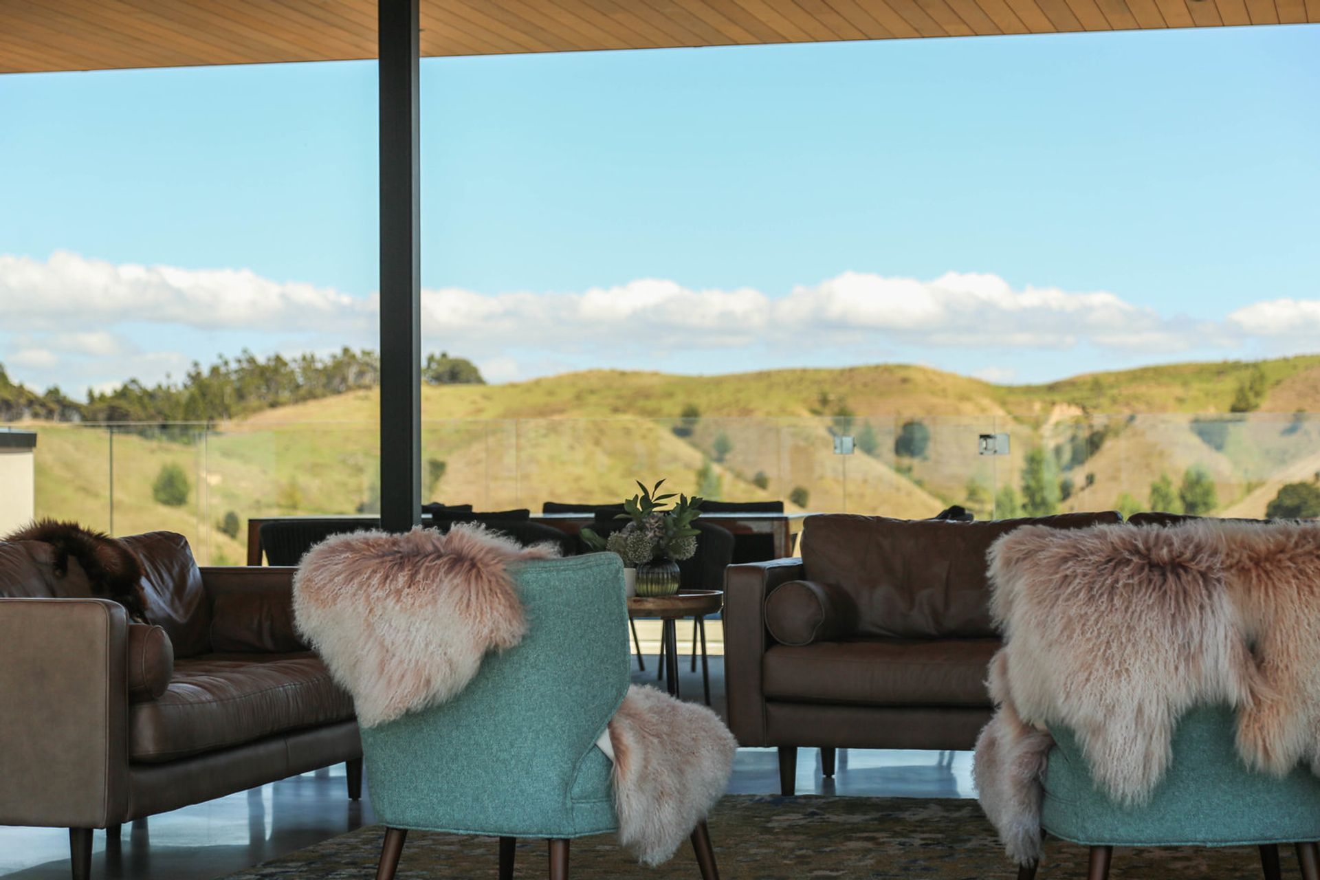 The cosy lounge area with a hillside backdrop.