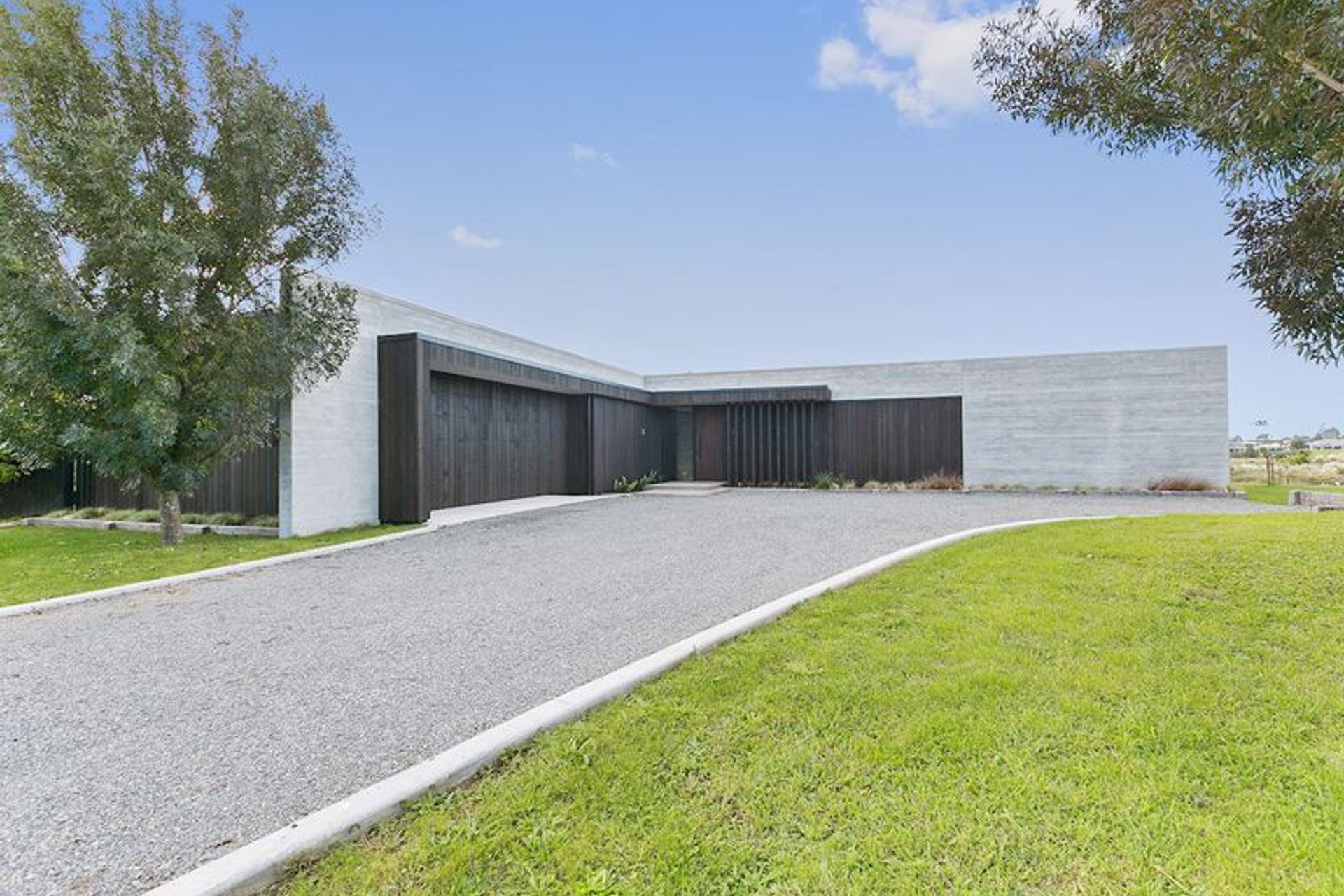 Clad in cedar and settled in a semi rural setting the spine of this ultra modern design is formed through perfectly executed insitu form poured concrete.