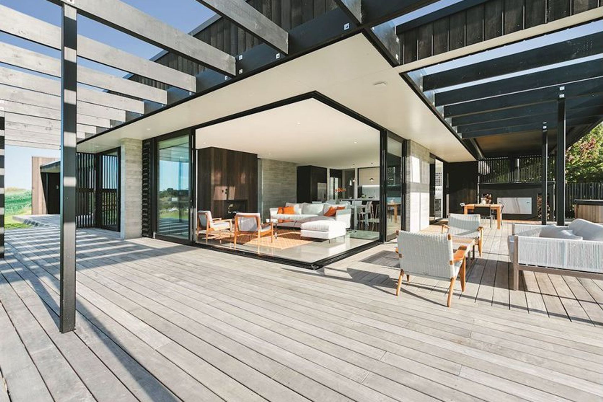 Huge stacker sliders ease the transition between refined interiors and extensive decking.