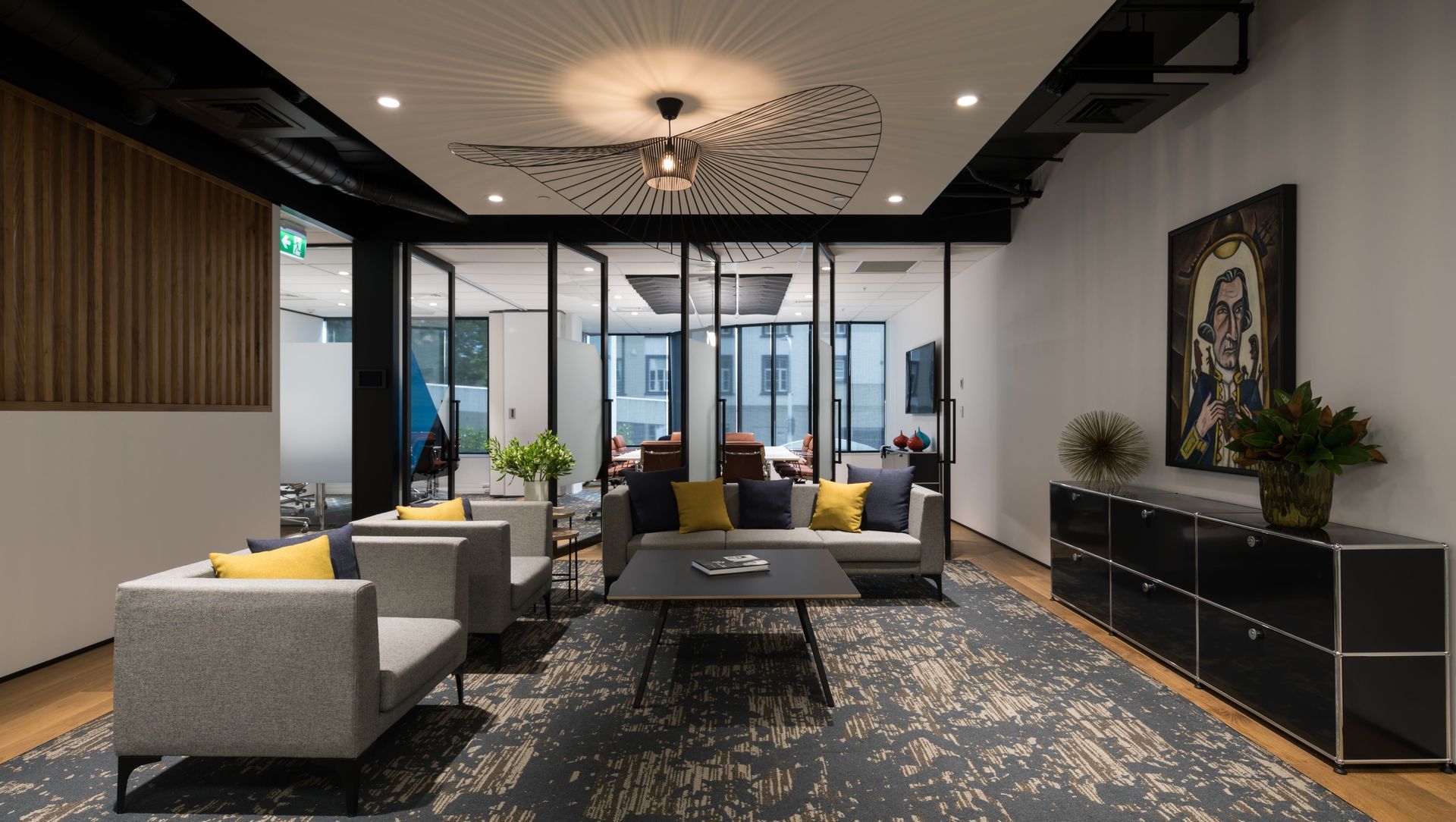 Reception lounge with feature carpet and wood frame flooring, with an operable wall to separate, or join, flexible meeting spaces beyond
