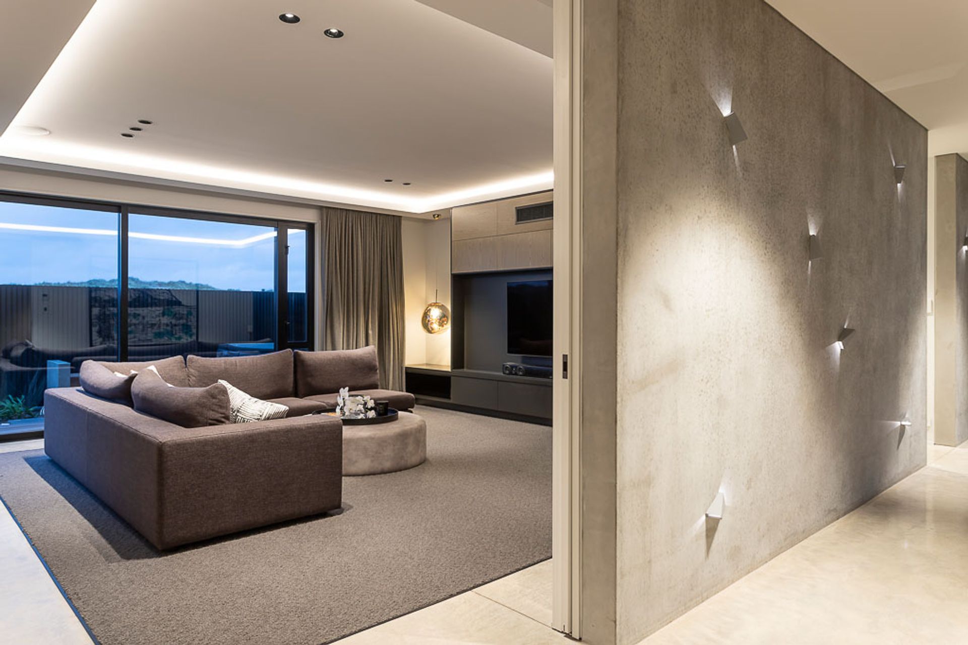 The textured entry wall with lighting feature, and the formal lounge on the ground floor.