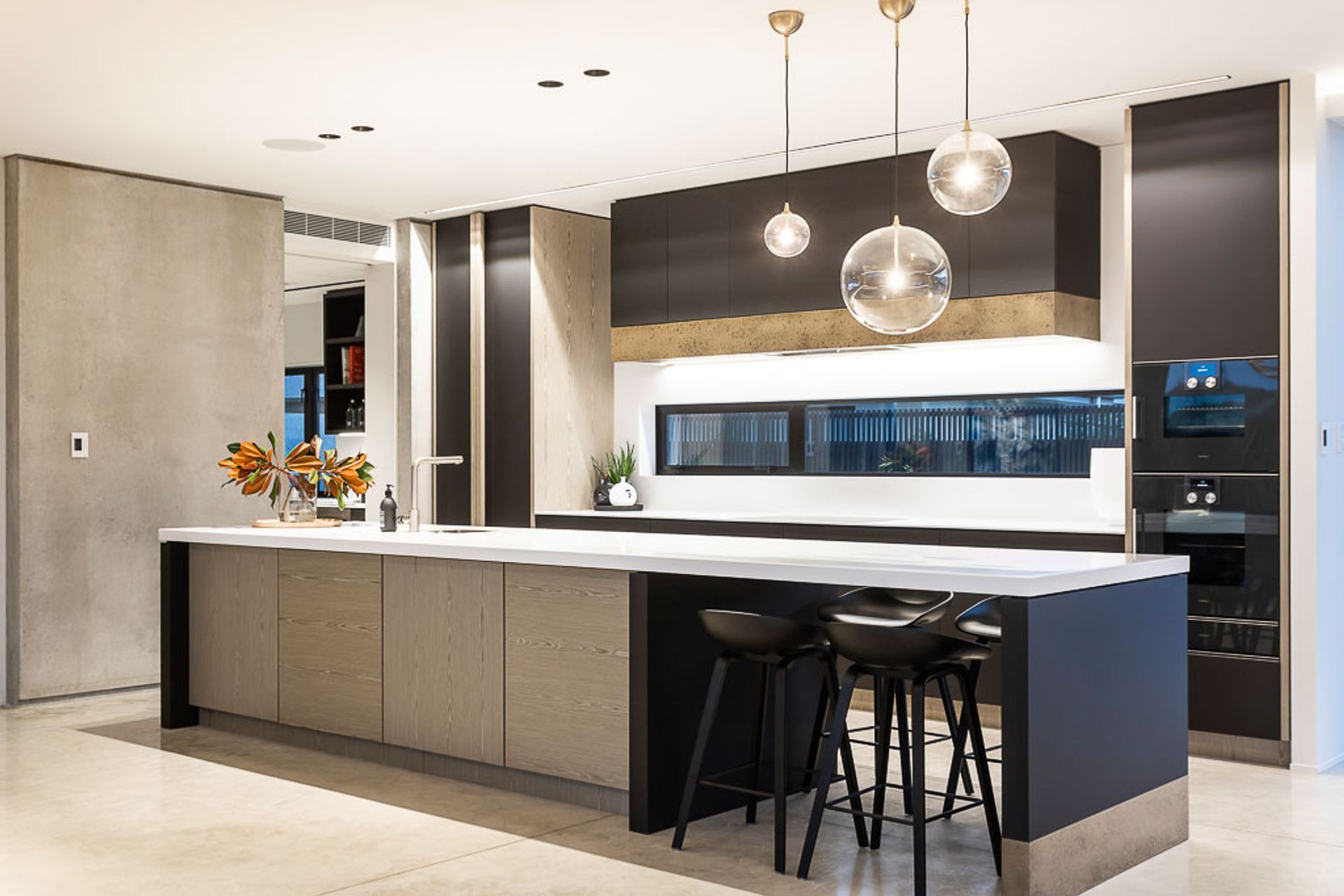 The kitchen features a dining space at one end, perfect for busy family lunches and breakfasts.