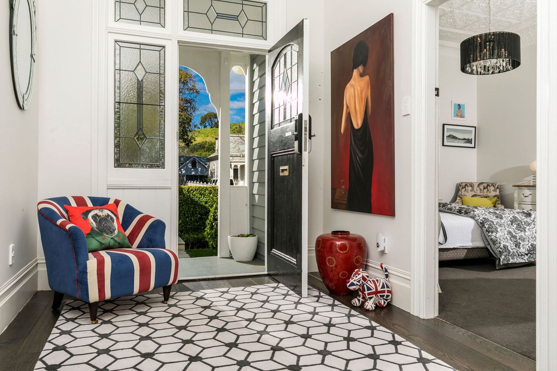 The eclectic entrance held a nod to the clients english heritage, and the custom designed rug echoed the pattern in the stained glass with it's diamond shapes.