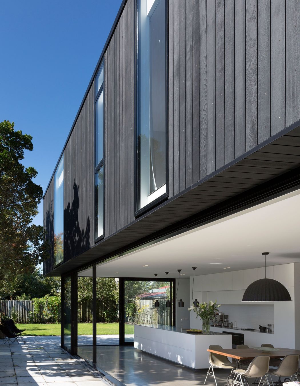 The kitchen opens up to the back garden via floor-to-ceiling sliding doors.