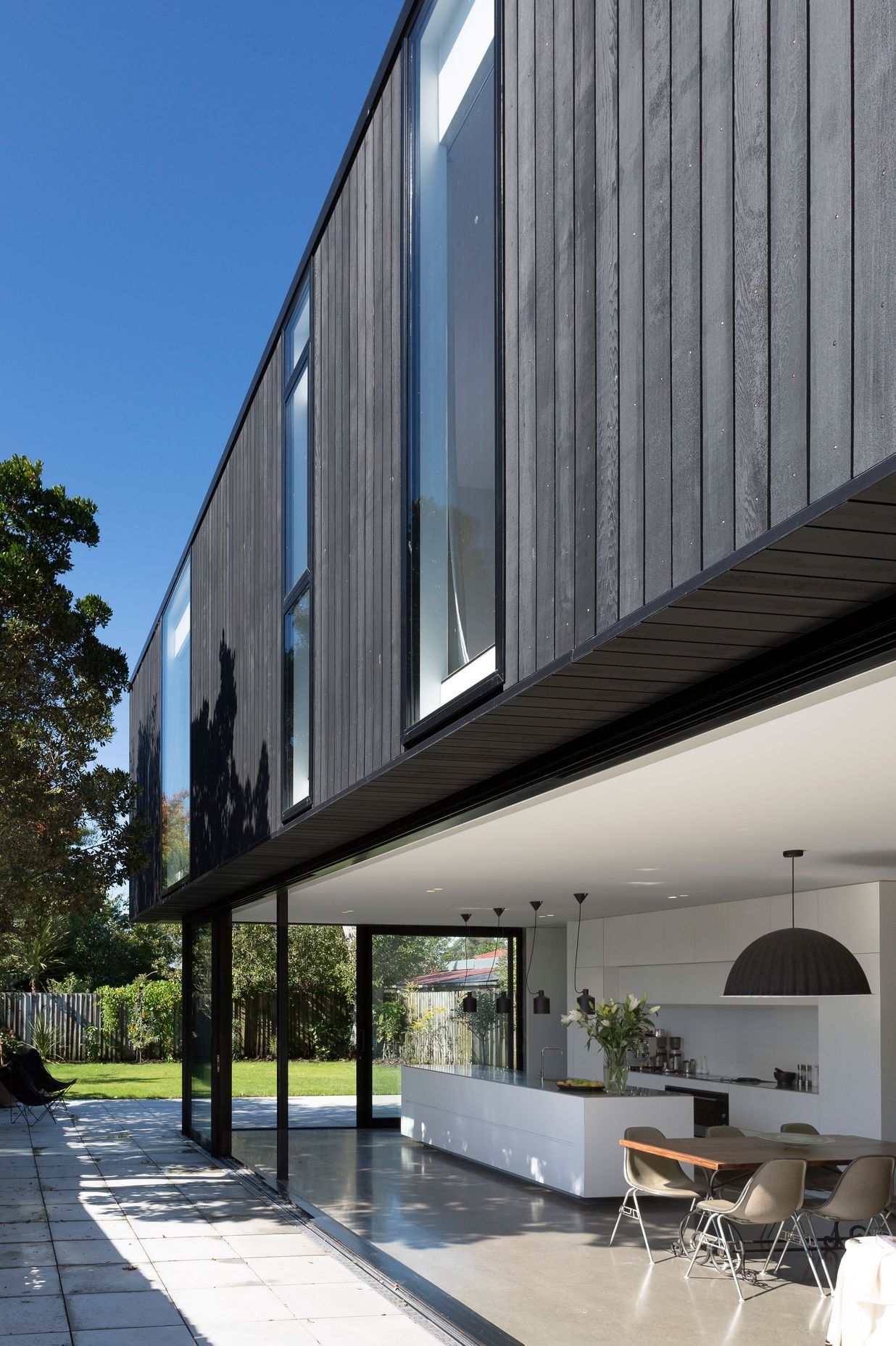 The kitchen opens up to the back garden via floor-to-ceiling sliding doors.