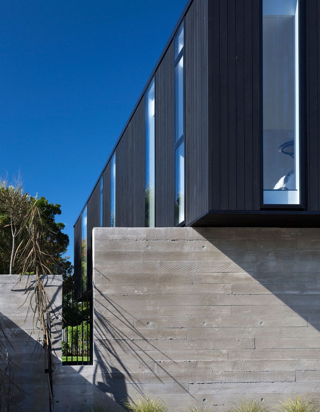 Rectangular cut-outs in the concrete walls emulate the penetrations in the upper box.