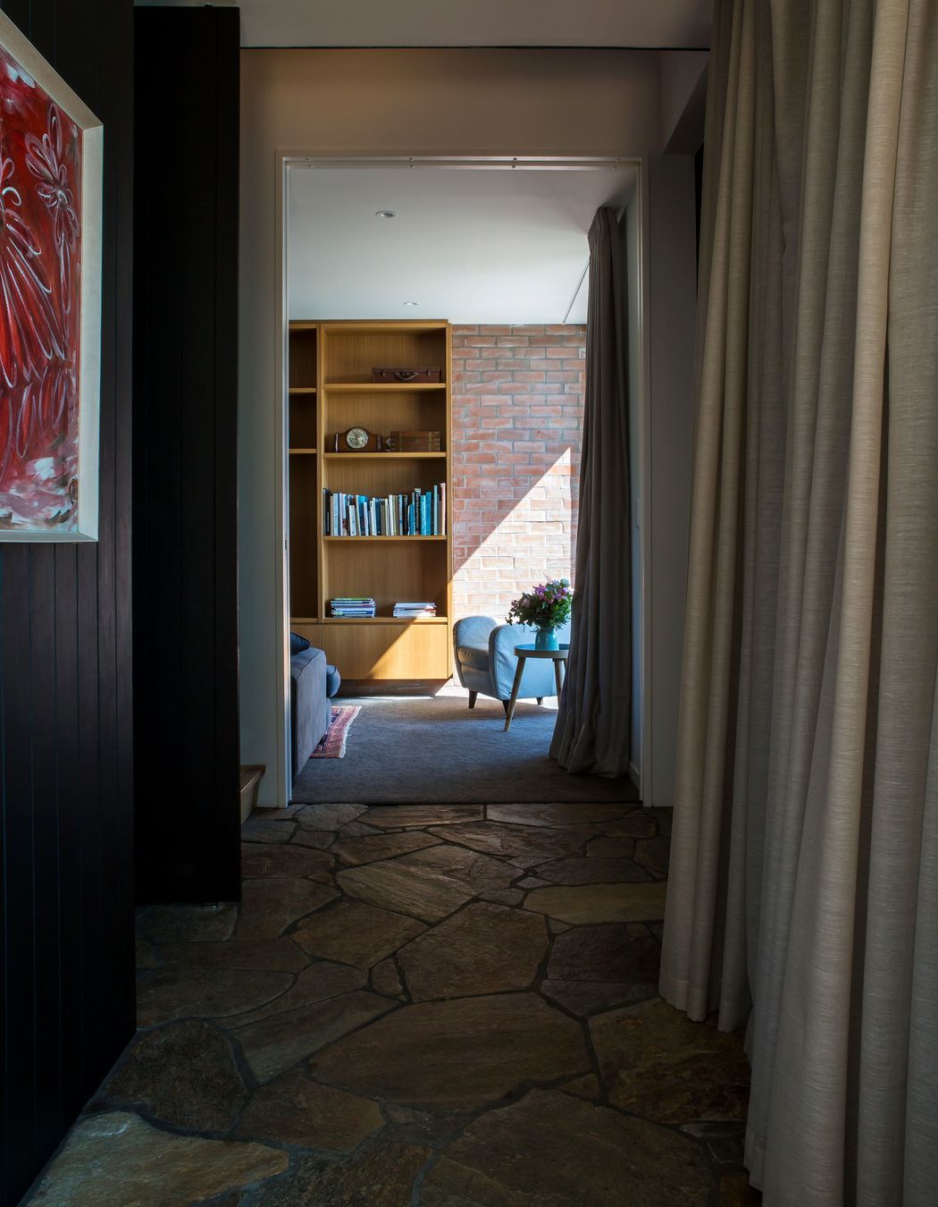 The ground-floor corridor leading to the media room with its crazy paving floor.