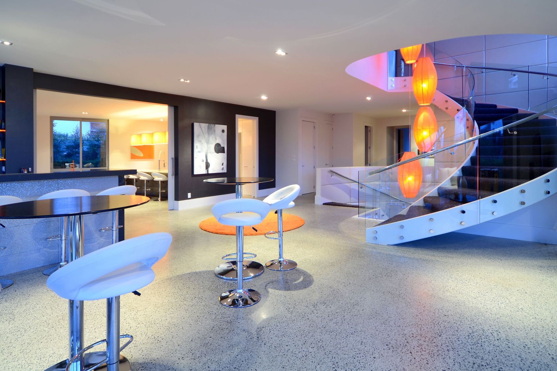 A curved staircase creates an archtectural form connecting the floors.