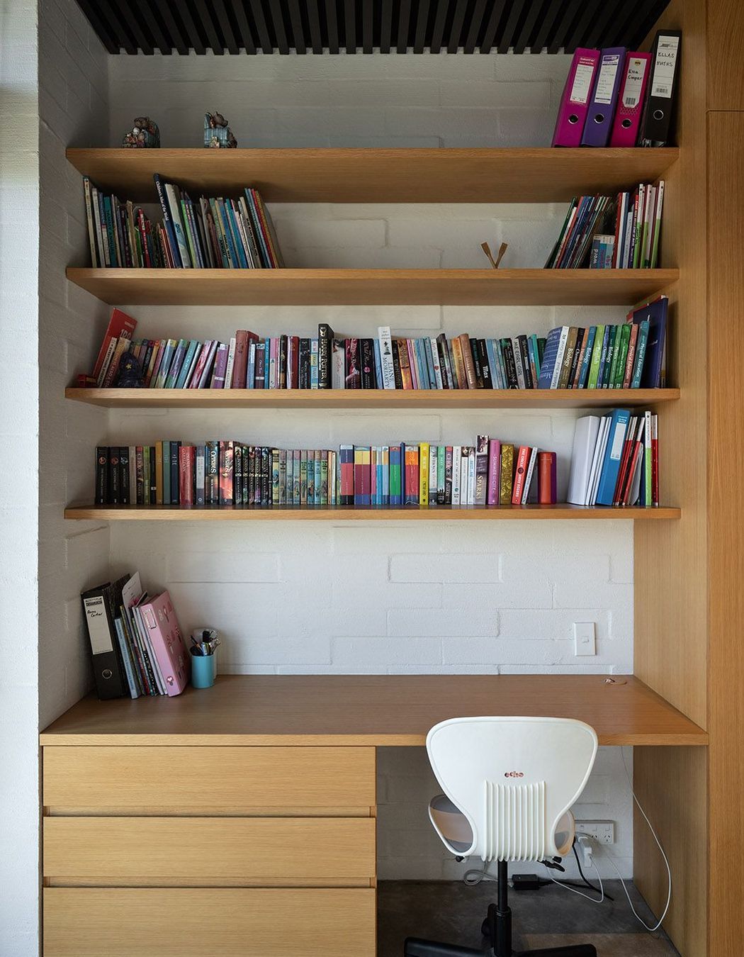 A dark cedar ceiling complements the lighter cabinetry and concrete block walls.