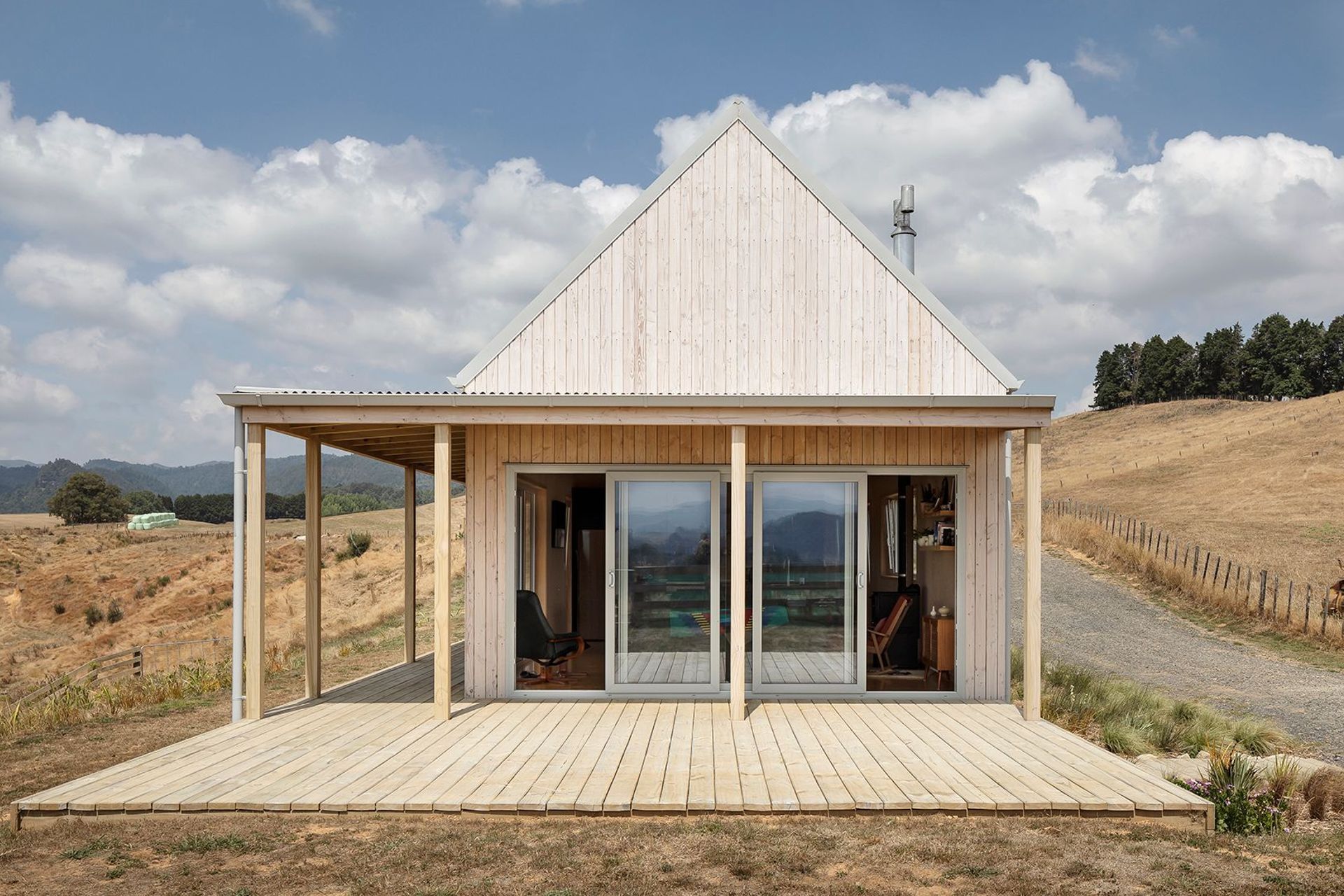 The south-western gable end hosts the lounge area, leading out onto a verandah that traverses the length of the building facing west.