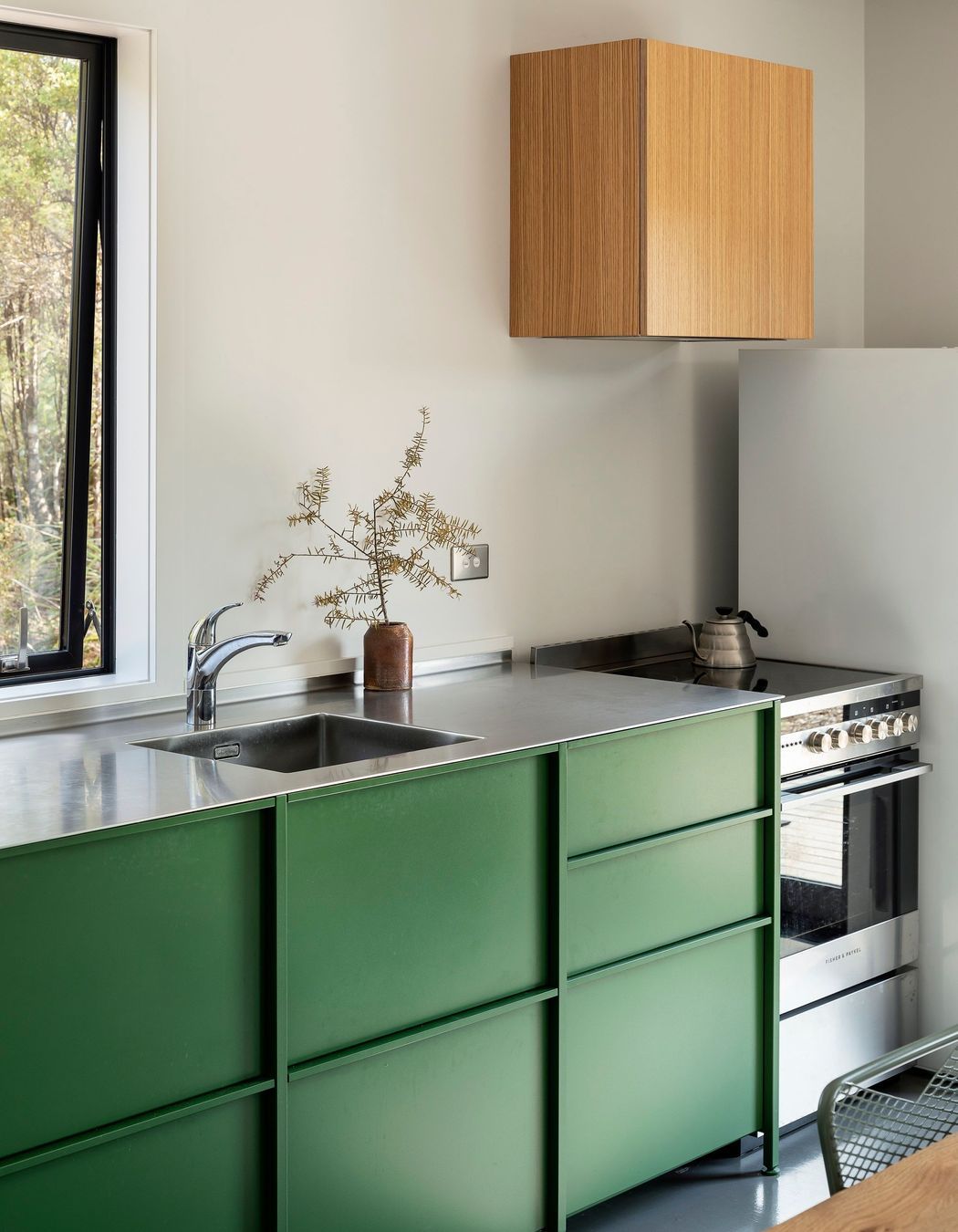 The kitchen is simple and functional, defined by the TKO cabinetry.