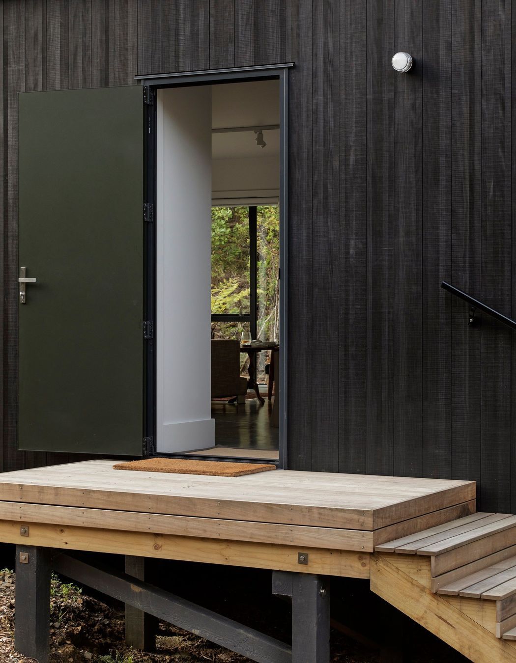 Stairs lead up to the main entrance, from which a choice is offered between the public and private parts of the home. 