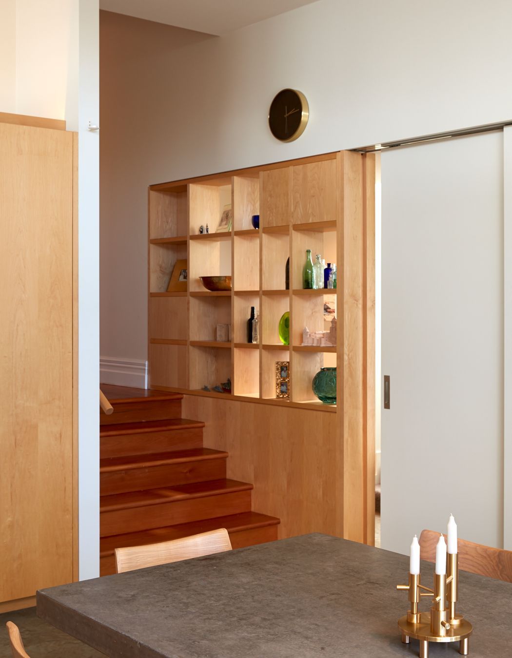 A built-in display case lines the steps up to the villa corridor.