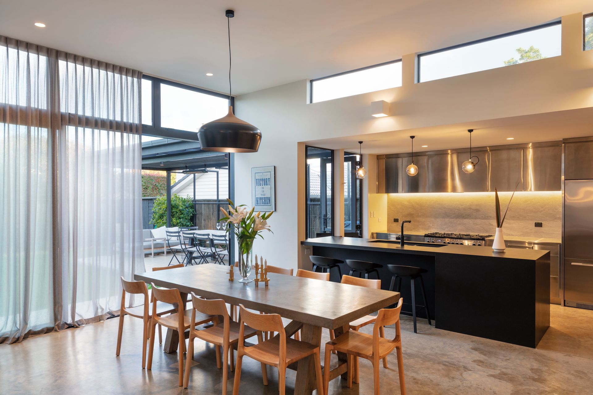 The kitchen and dining space leads out to the outdoor dining room.