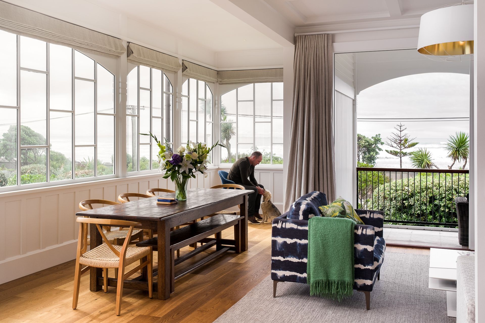 The upstairs dining and living area opens onto a verandah and a magnificent view of the ocean. The distinctive single-glazed windows have been replaced with double-glazed replicas.