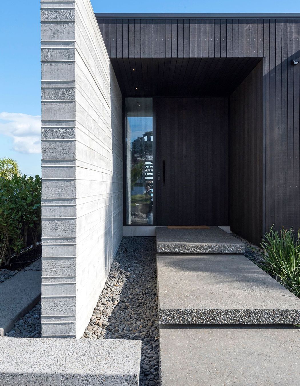 The main entrance leads straight through into a double-height corridor and staircase.