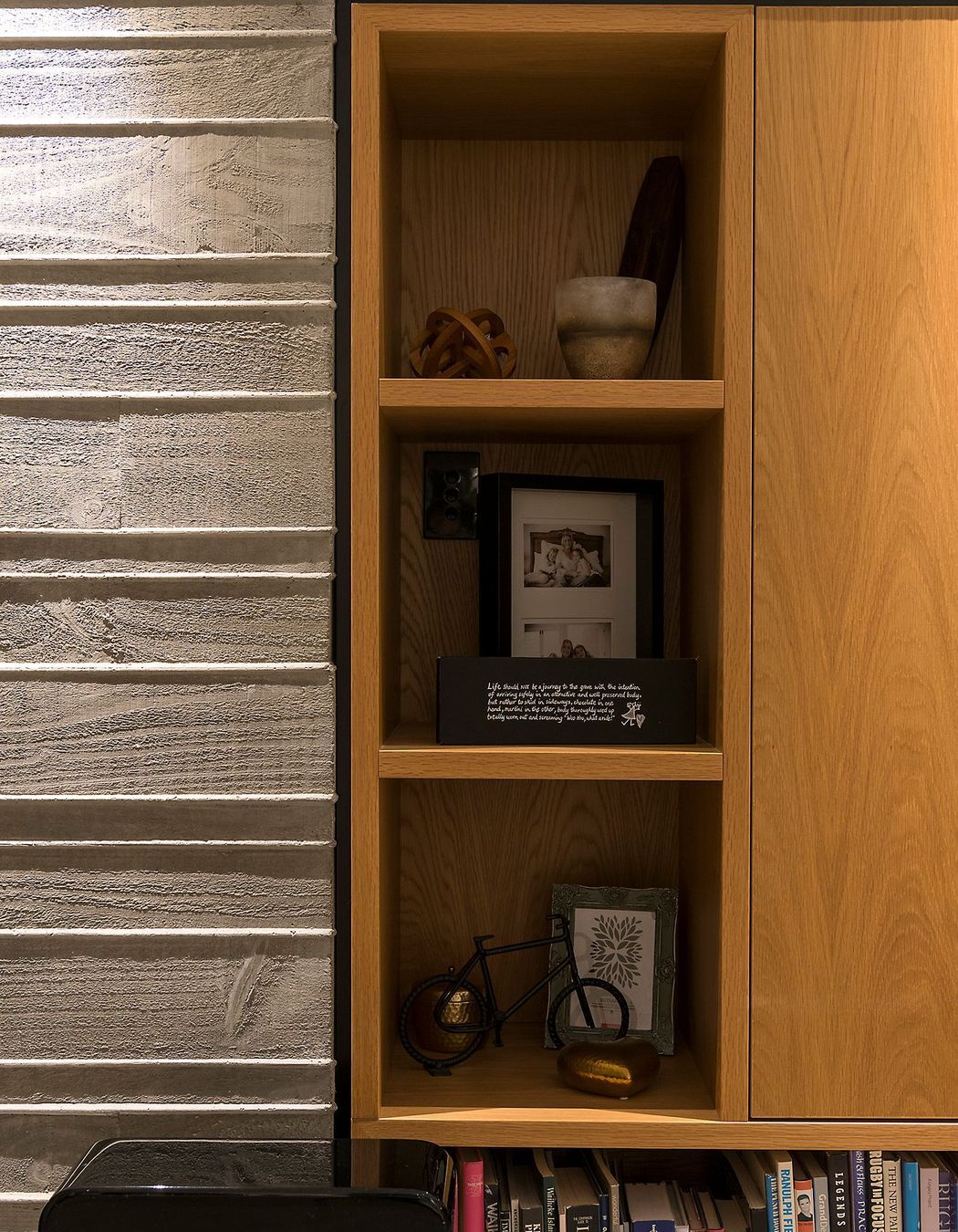The home utilises bespoke cabinetry in pale oak, adding warmth to the concrete walls.