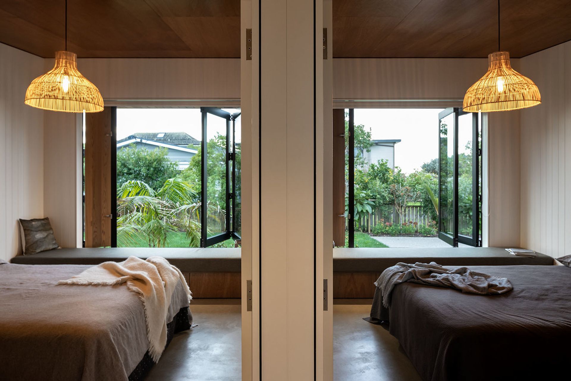 The twin guest bedrooms have extra built-in day beds which provide extra sleeping spaces, while large windows open up the rooms to the garden.