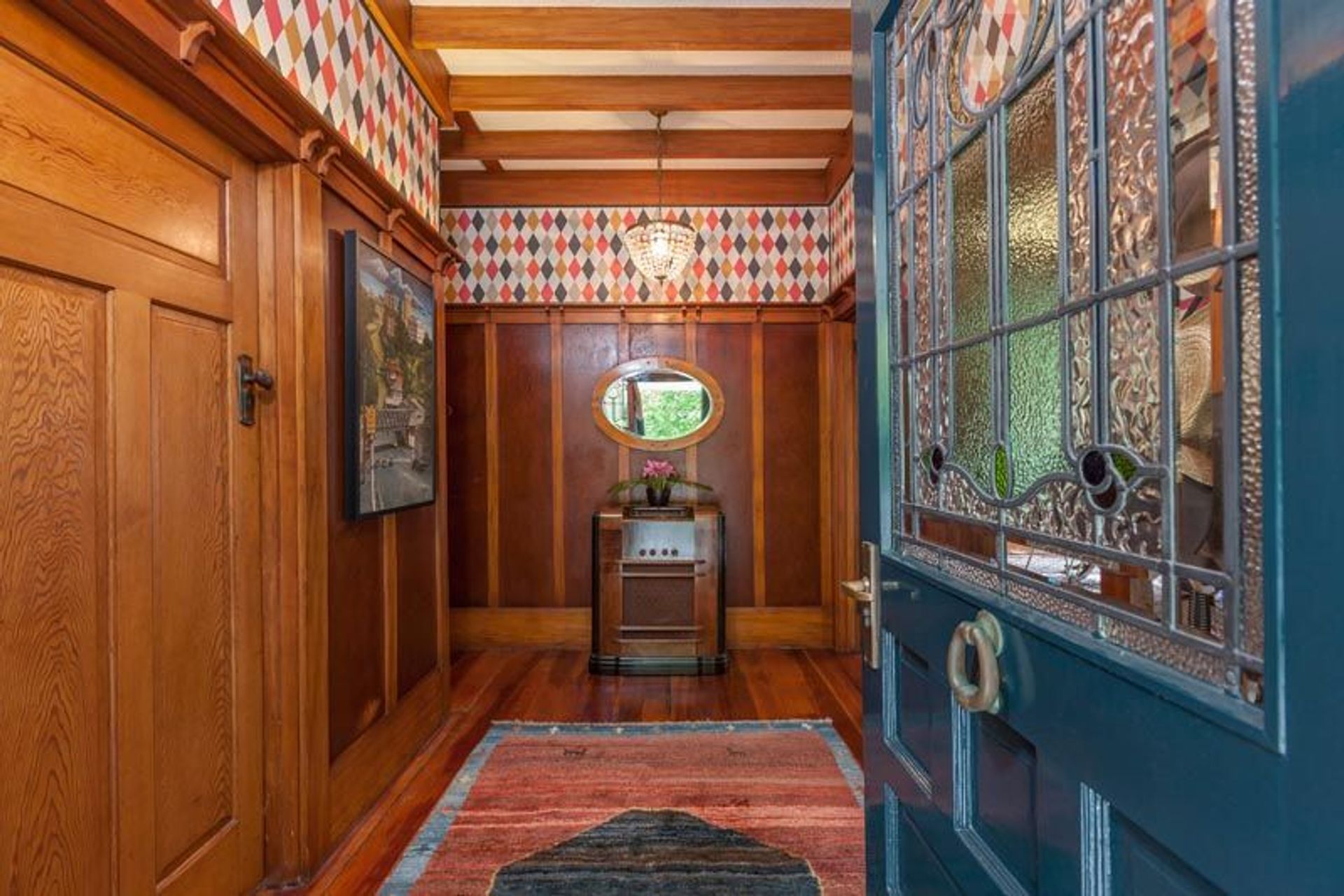 A "statement" entrance is balanced by a strong uplifting wallpaper