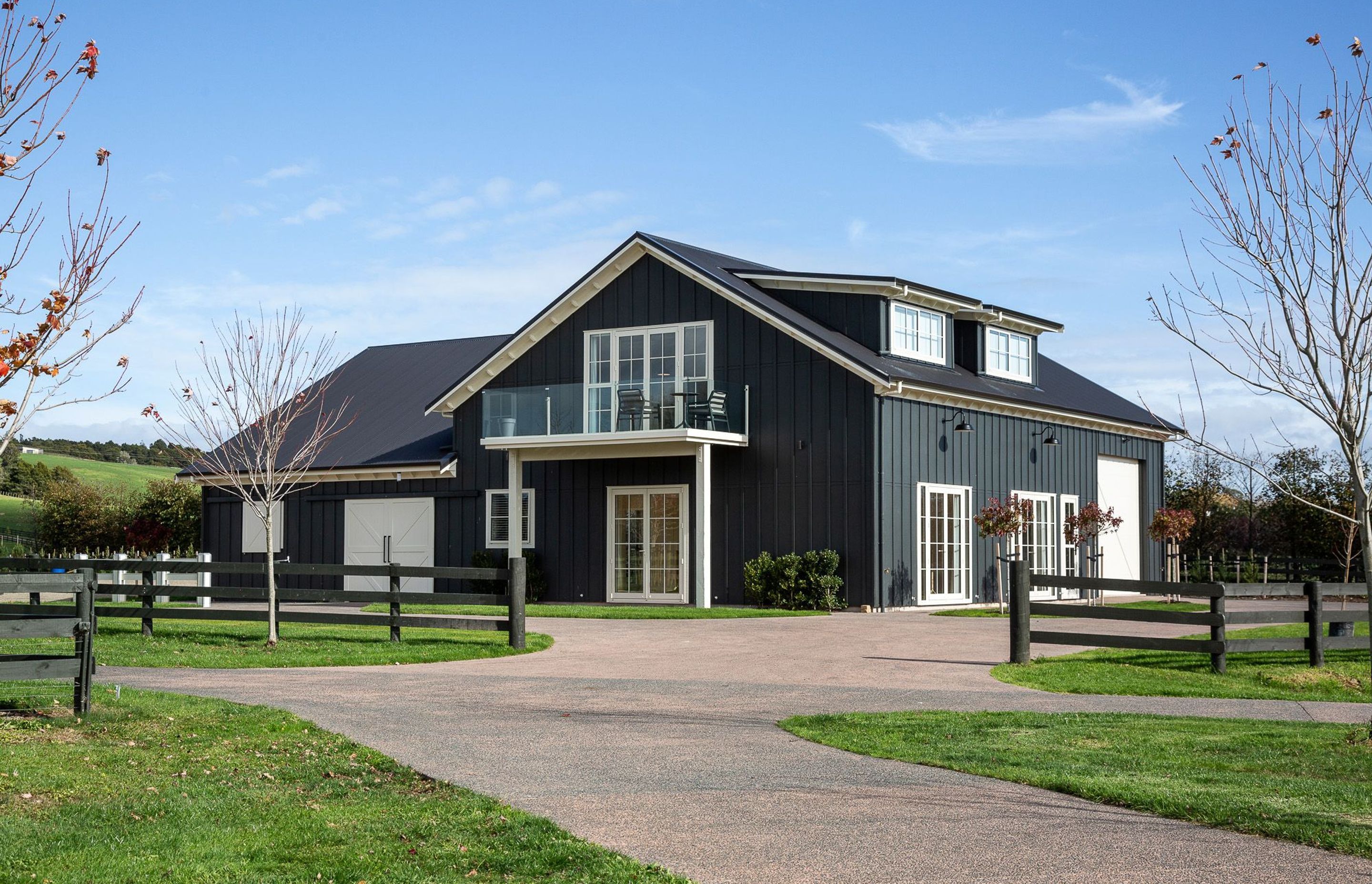 Goodwood Barn is a two-storeyed gable form that features barn doors, French doors and dormer windows in the roof structure.