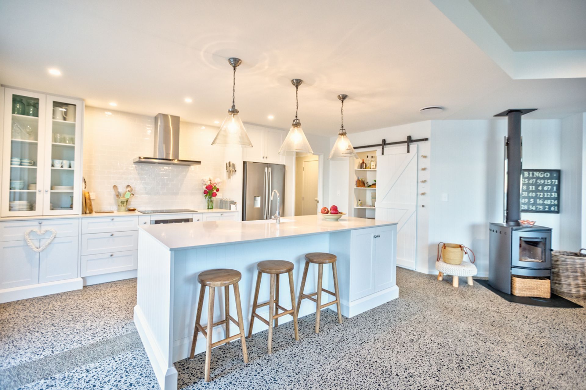 Stunning feature details include the barn door, the library and the central kitchen island.