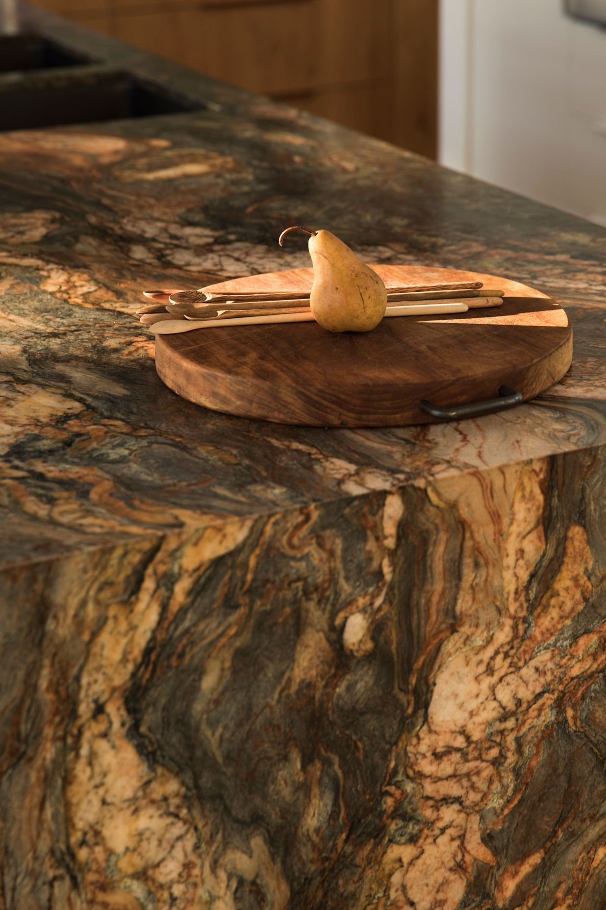 Rich warm tones and patterns can be seen in the quartzite stone kitchen island.