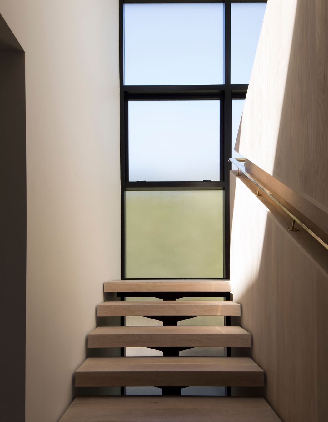 The staircase landing makes the most of the light and the surrounding views.