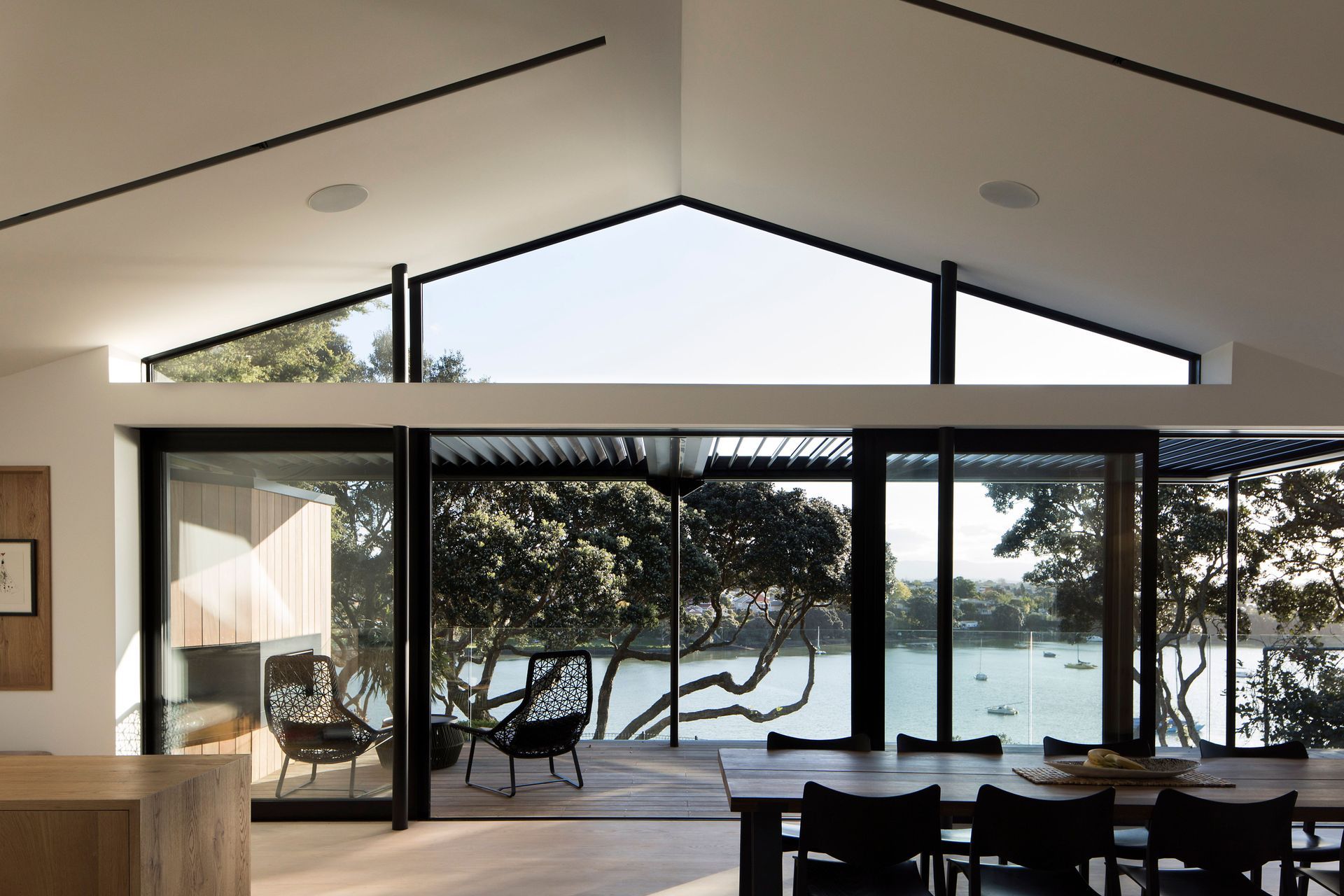 In the living spaces, the ceiling of the existing brick-and-tile home has been raised to create a triangular clerestory windows that opens up the volume and adds light and shadow.