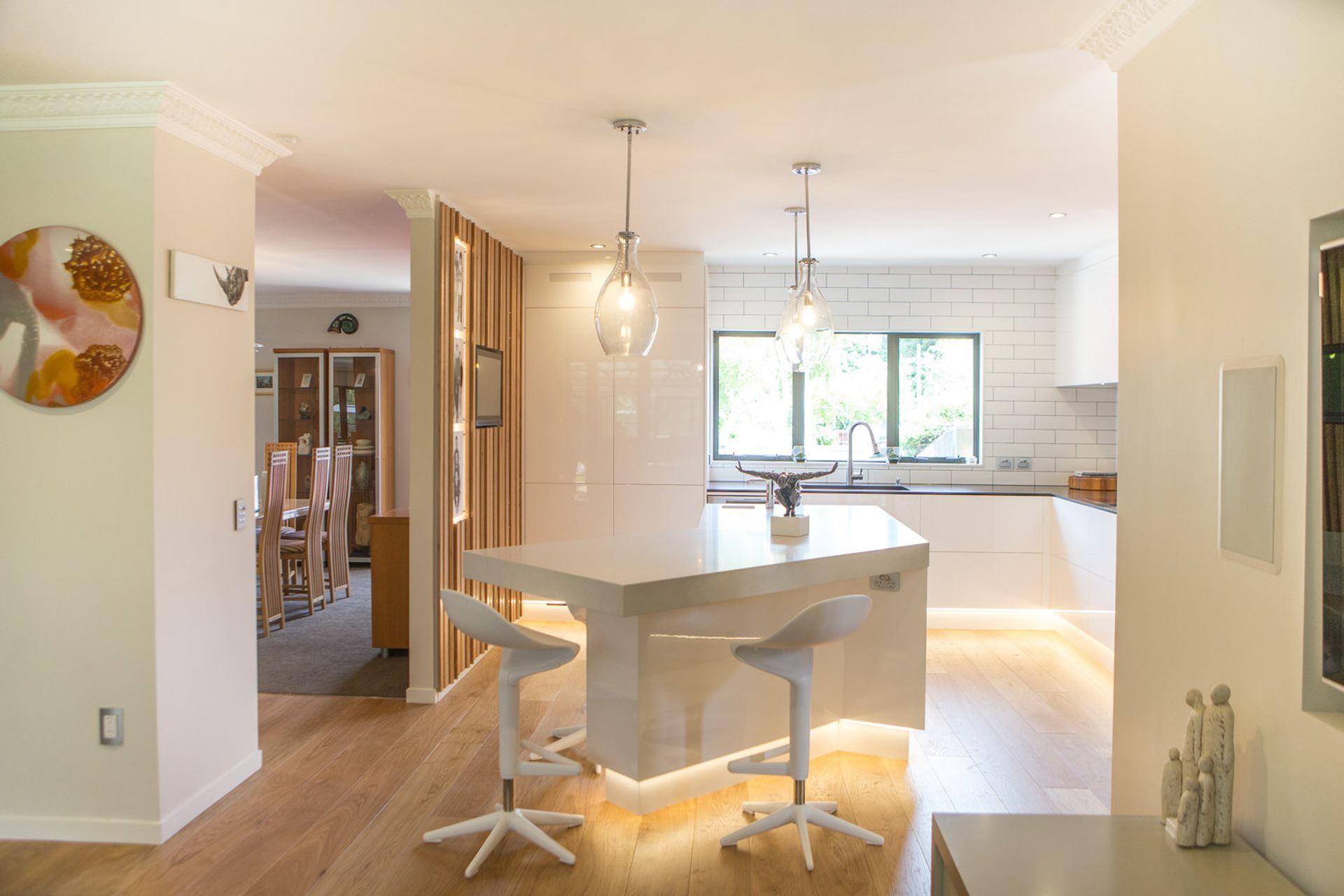 The angled island centres the space, providing a grounding for gatherings and entertaining, as well as drawing people in from the adjacent spaces.