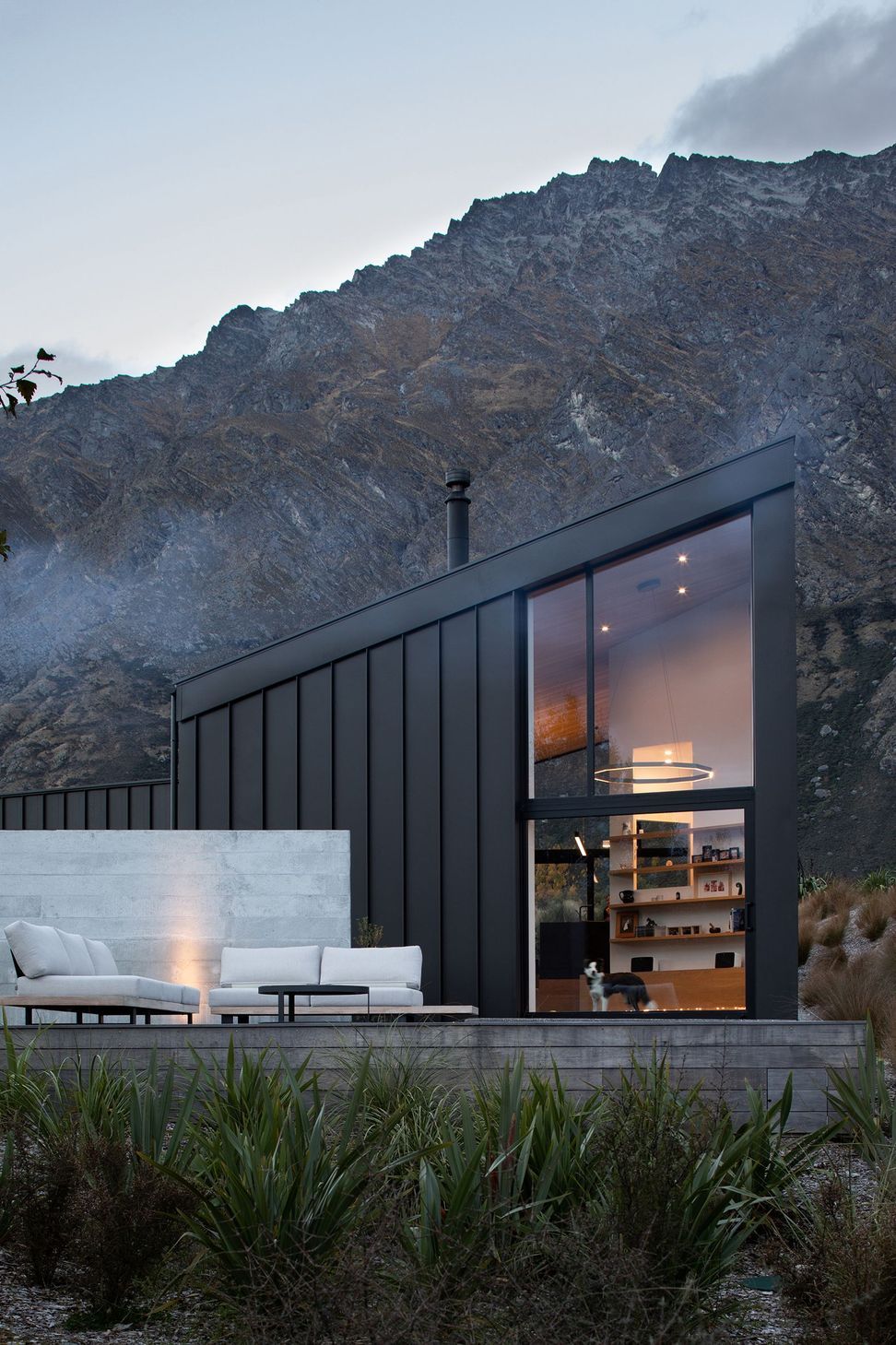 The double-height space in the main living area maximises views of the landscape, while the ground floor opens up into an outside terrace.