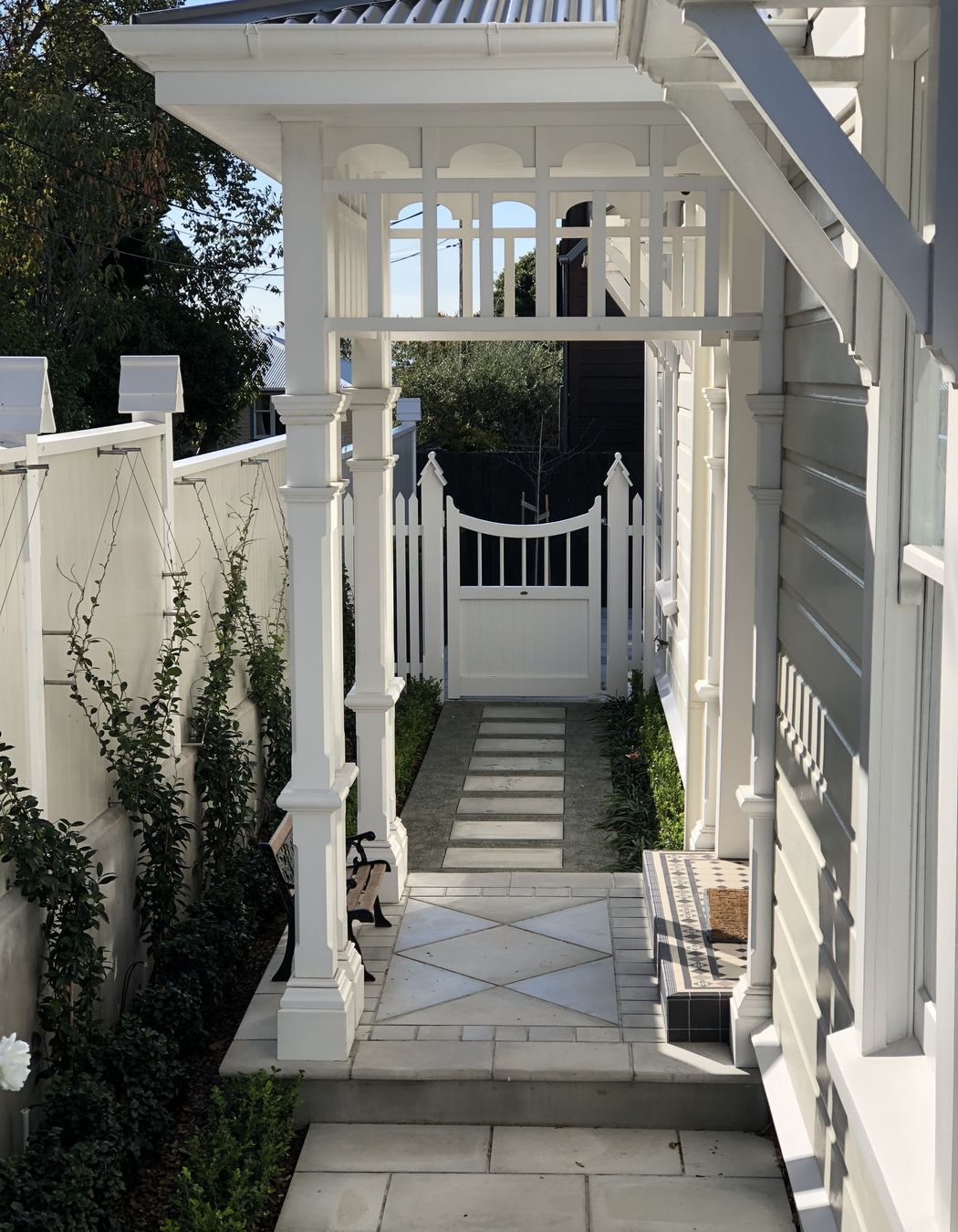 A jasmine espalier trained on stainless steel wires runs length of the new side fence