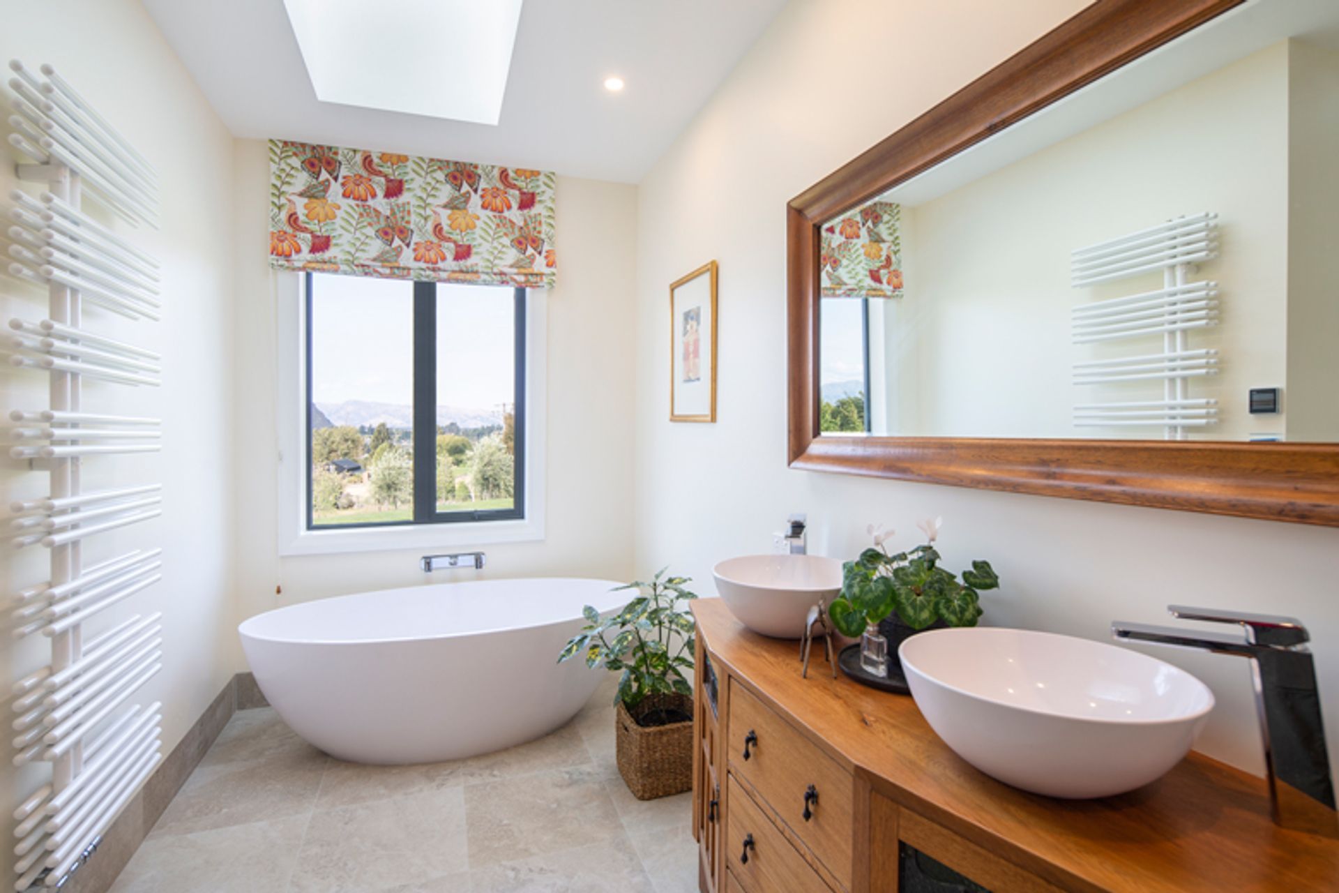 The family bathroom is a light and generous space with views towards the Southern Alps in the distance.