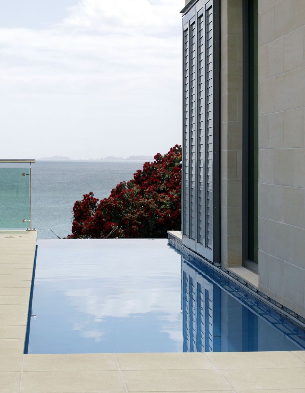 Lap pool adjacent to stone clad wall