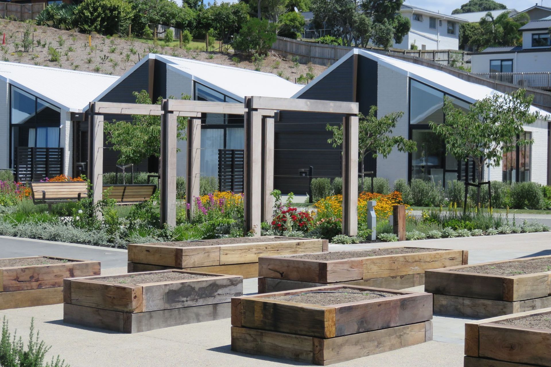 A mix of landscaping types, including raised vegetable beds, provide residents with points of interaction within the landscape.