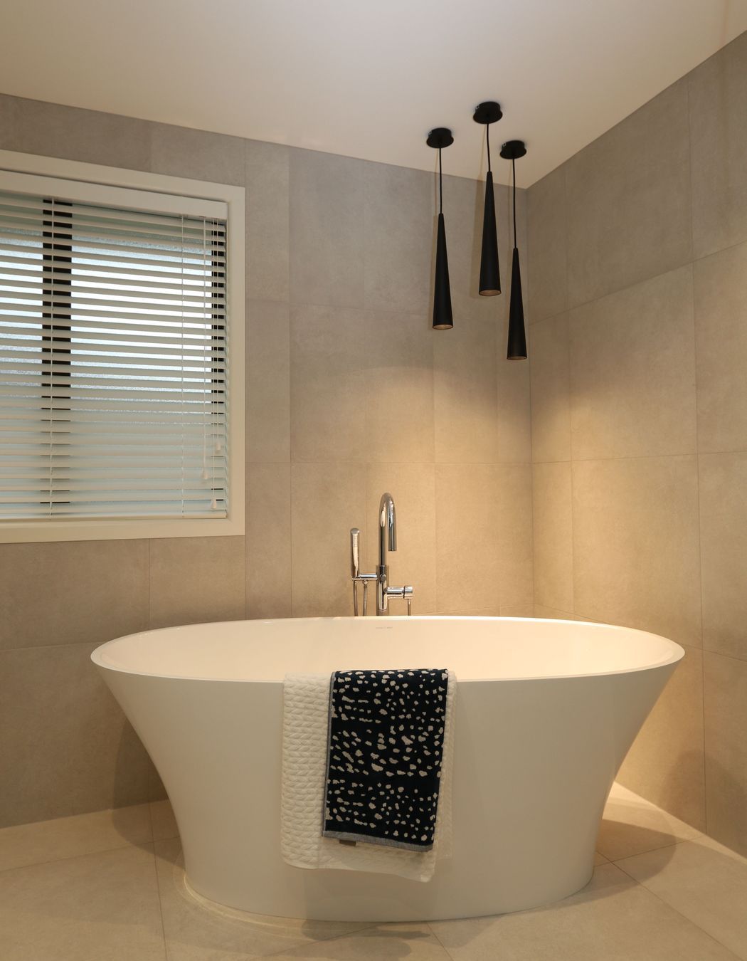 The main bathroom in this clients home features a matching theme with the same feature bath creating a statement with the gorgeous free-standing bath filler.