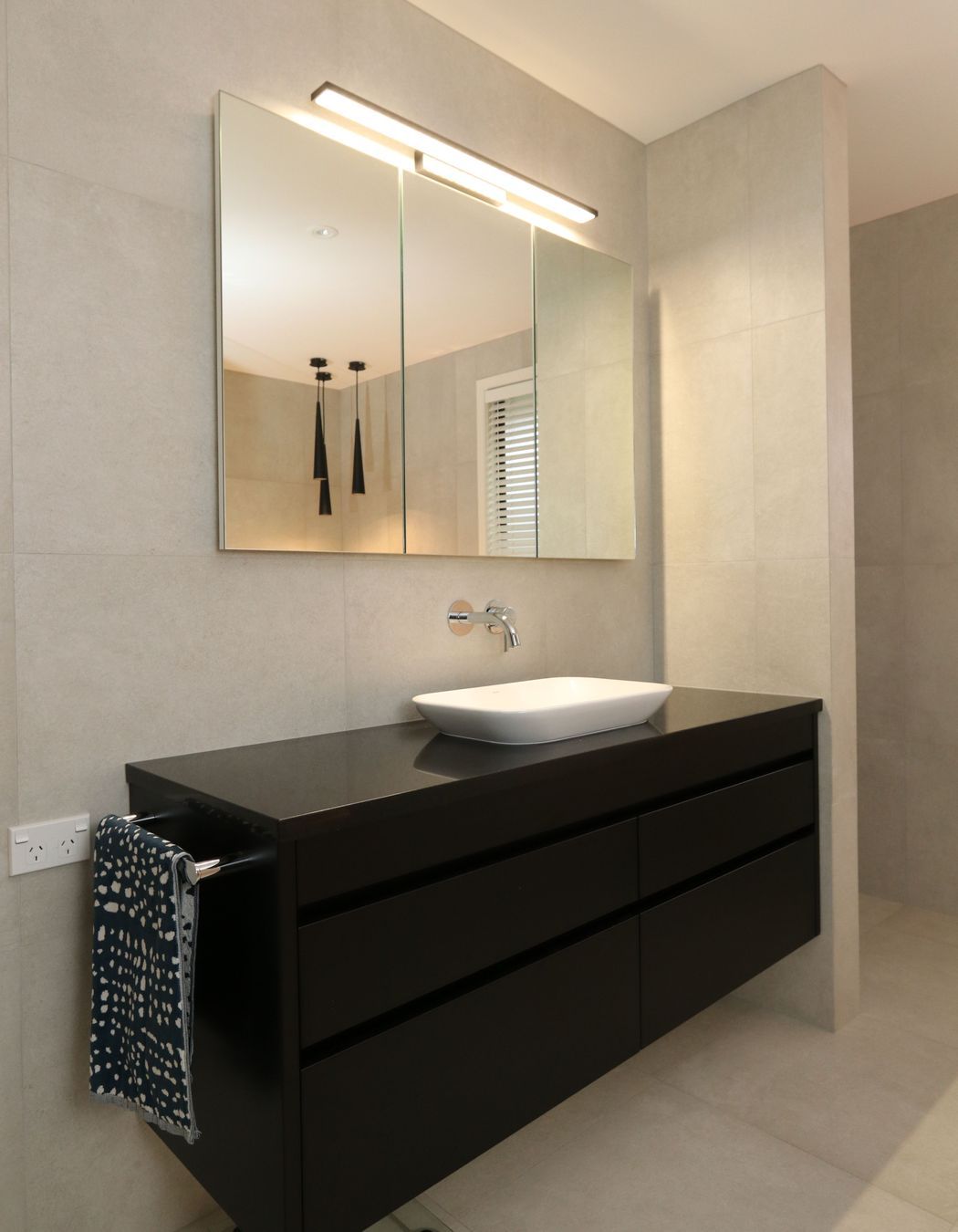 Recessed mirror cabinets in their main bathroom provides discreet storage space for the whole family without intruding on the spacious area.