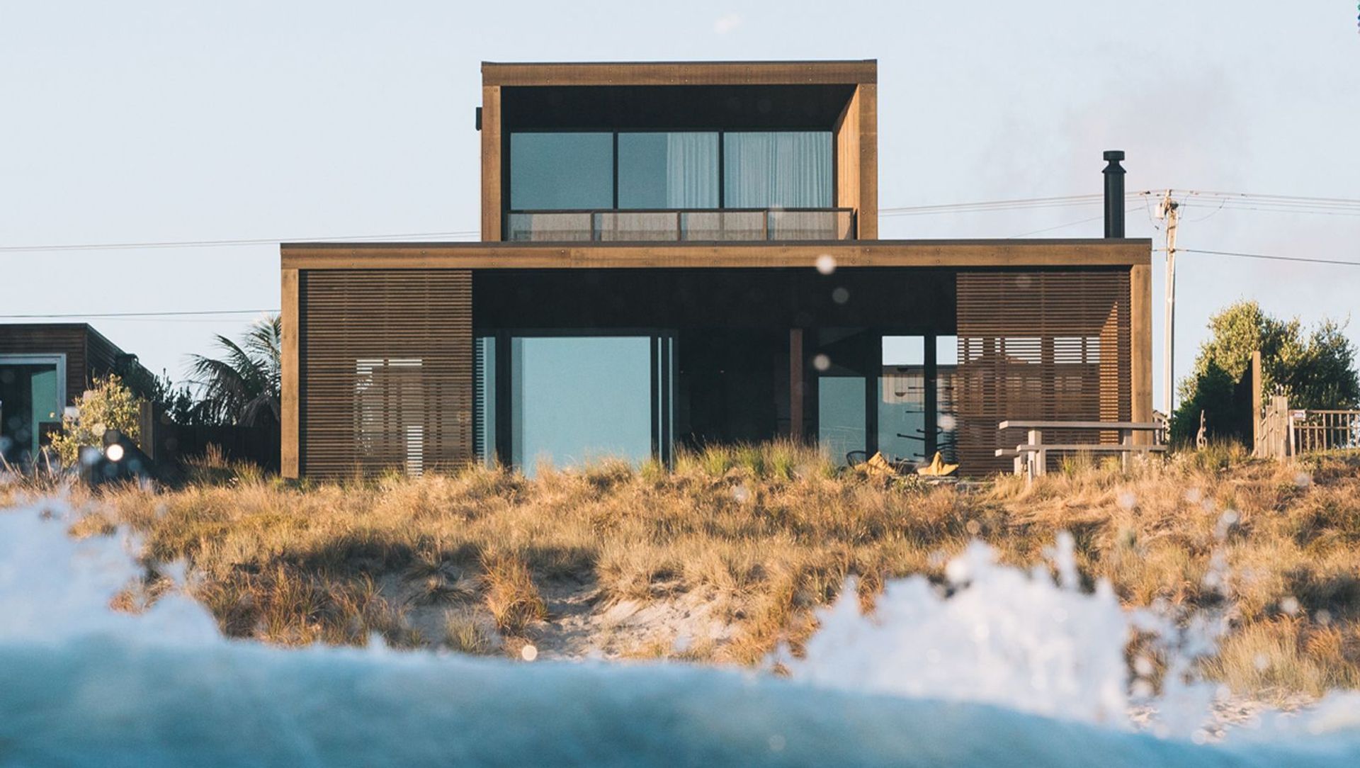 Sitting within the dunes on Papamoa Beach, Tauranga, this home is as close to beachfront as you can get. 