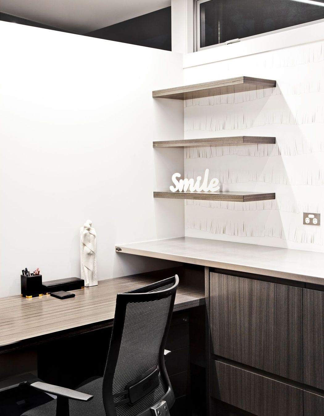 An understated office...with wallpaper to create a playful element to a practical space...and make you smile.