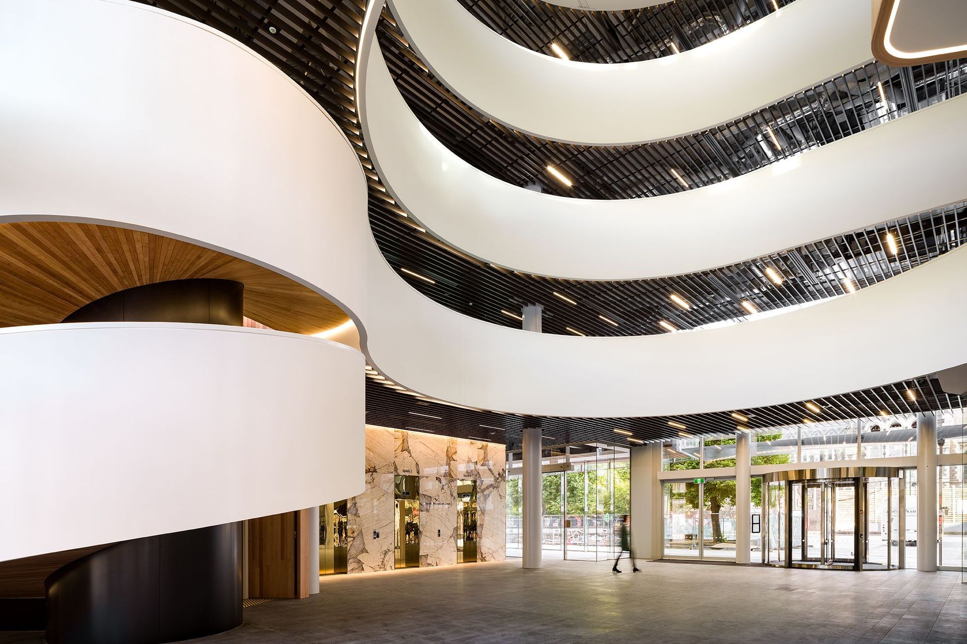  The staircase appears like a streaming white ribbon that curls around the atrium space and up the building, before it ends on the fifth-floor.