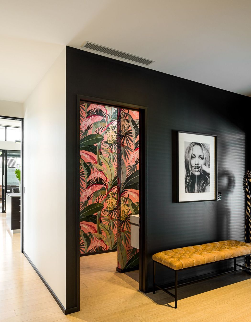 A vibrant botannical print in the powder room adds a splash of colour to the interior design scheme.