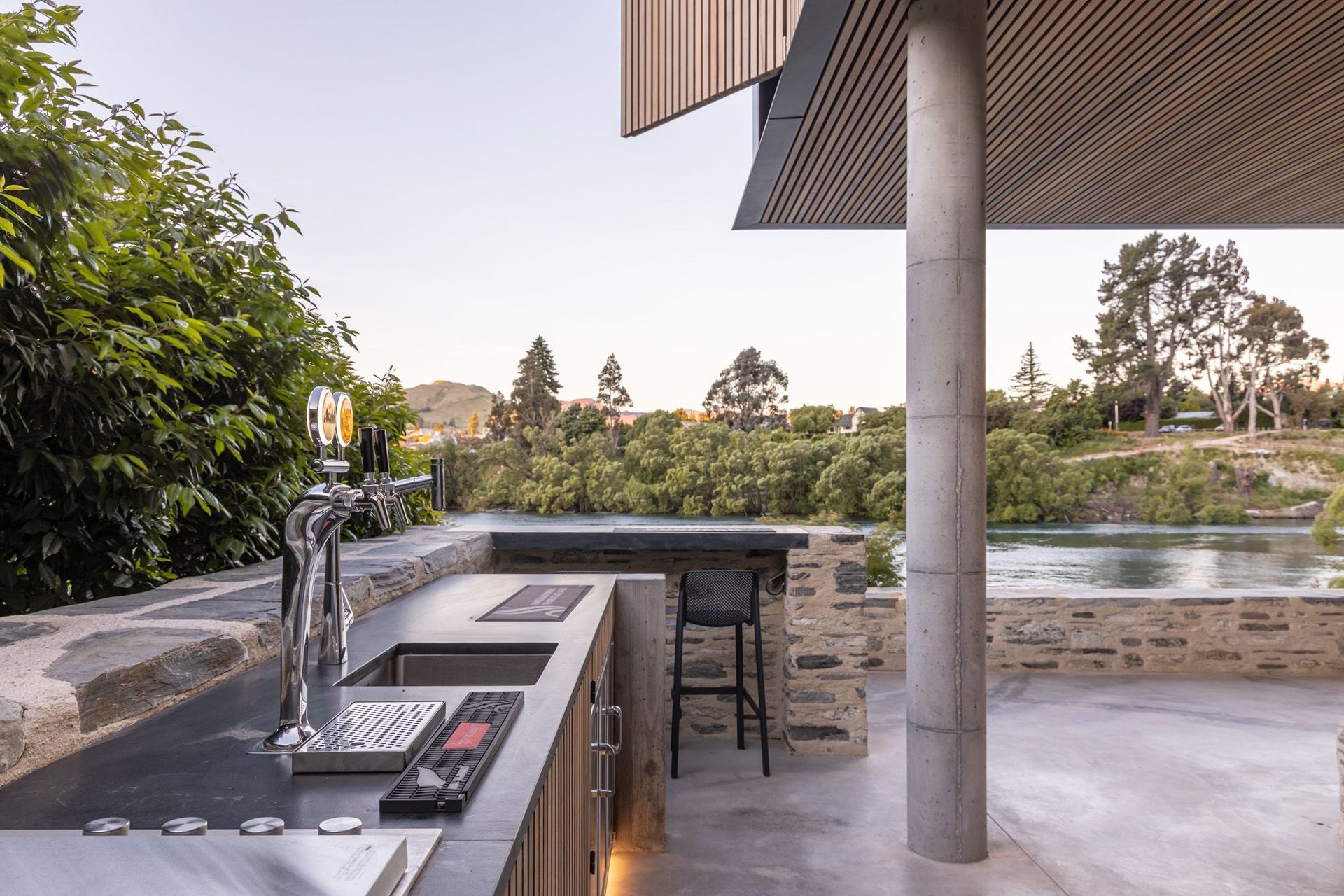 An enclosed bar and barbeque area stretches along one wall of the outdoor room and features two beers on tap!