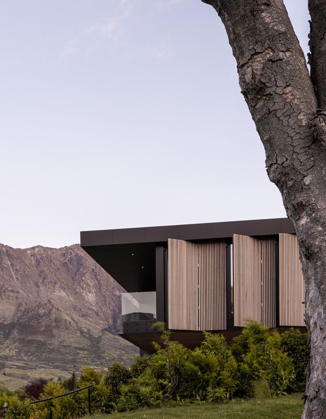 Side elevation showing the overhangin roof at the front and the cedar screens.